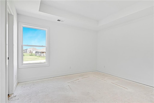 unfurnished room featuring visible vents, baseboards, and a raised ceiling