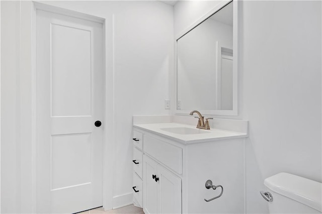 bathroom with toilet and vanity