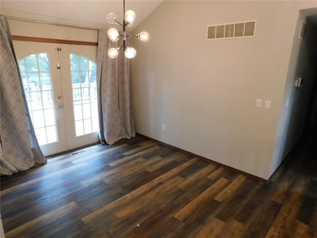 unfurnished dining area featuring dark wood-type flooring, lofted ceiling, an inviting chandelier, and french doors