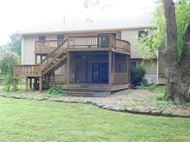 back of property with a yard, a deck, and ac unit