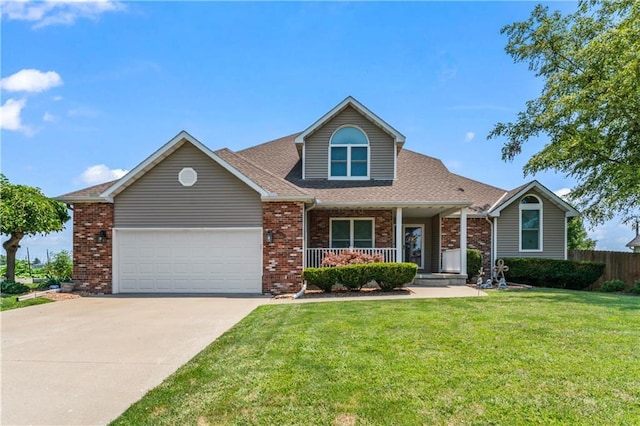 view of front of property with covered porch, a garage, and a front lawn