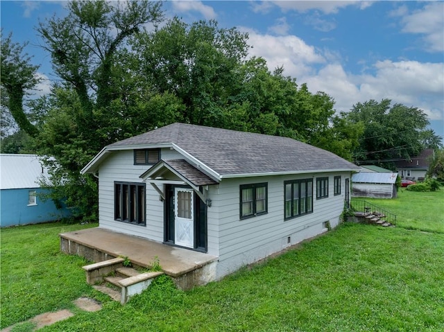 back of property with a lawn