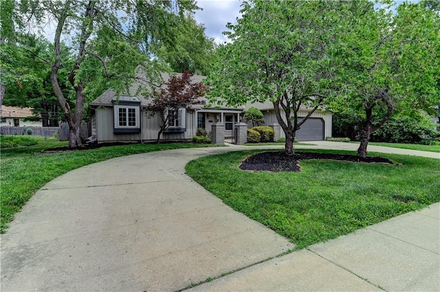 ranch-style house featuring a garage and a front yard