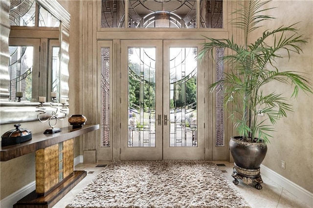 entryway featuring french doors and light tile patterned floors