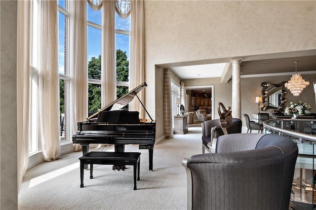 interior space featuring decorative columns, a wealth of natural light, and light colored carpet