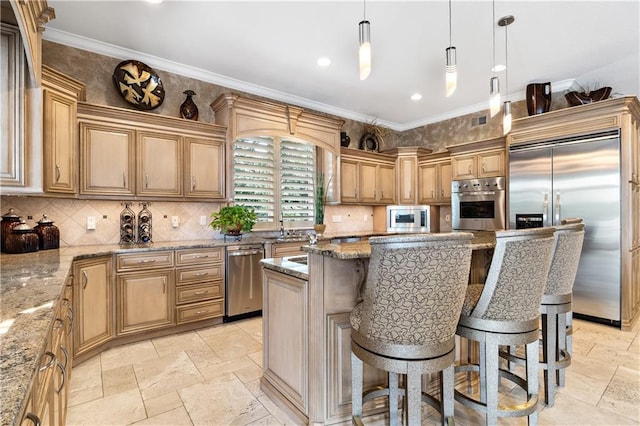 kitchen with built in appliances, a breakfast bar, light stone counters, a kitchen island, and stone tile floors
