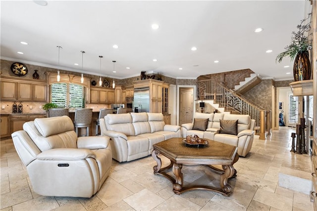 living room with recessed lighting, ornamental molding, and stone tile flooring