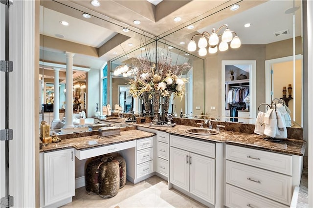 bathroom featuring vanity, tile patterned floors, decorative columns, and a tray ceiling