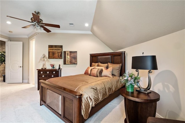 bedroom with vaulted ceiling, light colored carpet, crown molding, and ceiling fan