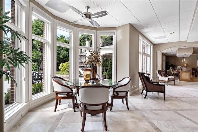 sunroom with ceiling fan and plenty of natural light