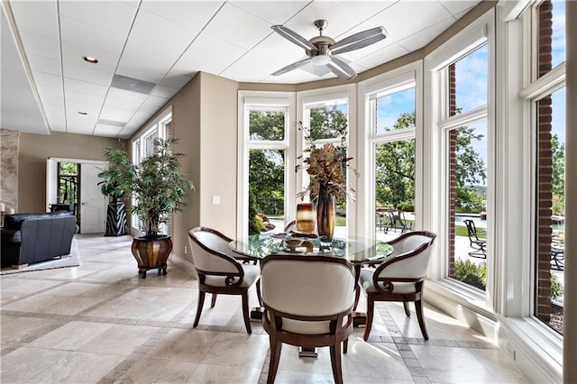 sunroom with a wealth of natural light and ceiling fan