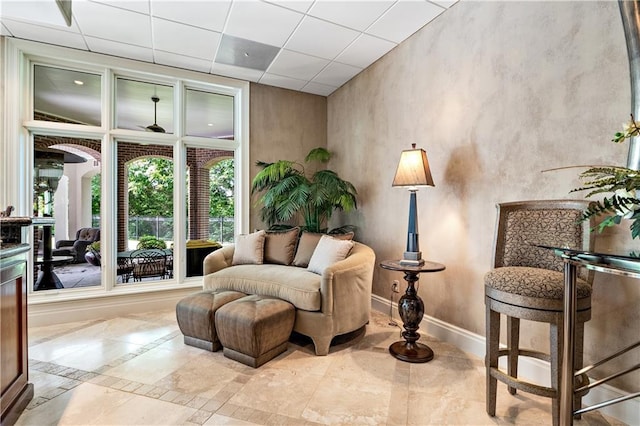 living area with a paneled ceiling