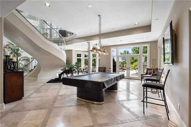 playroom featuring a high ceiling, billiards, french doors, a raised ceiling, and light tile patterned floors