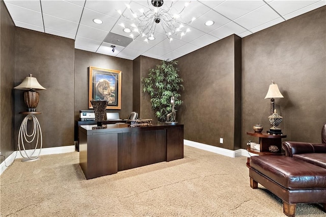 home office with light carpet, a drop ceiling, and an inviting chandelier