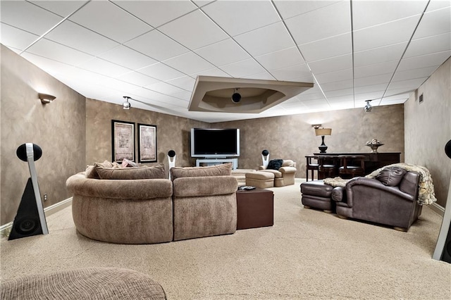 carpeted living room with a drop ceiling