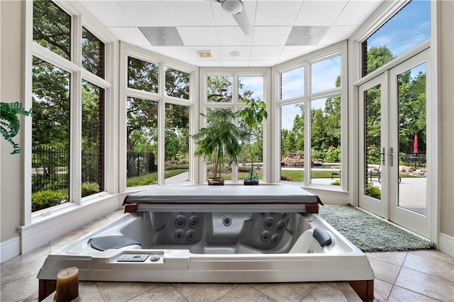 sunroom with french doors and a hot tub