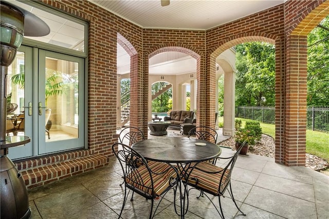 view of patio / terrace featuring french doors and fence