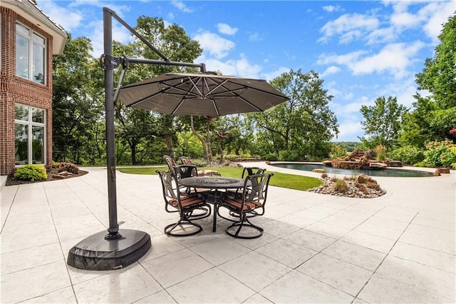 view of patio / terrace with outdoor dining space, an outdoor pool, and a jacuzzi