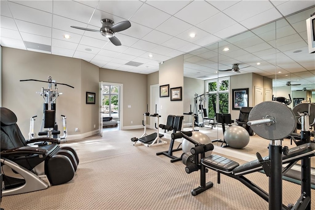 gym featuring a drop ceiling and ceiling fan