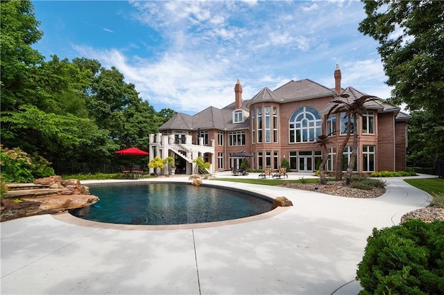 pool with a patio and stairway