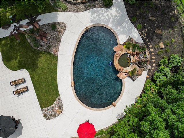 view of swimming pool with a yard and a jacuzzi