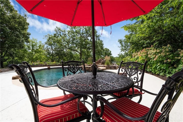 balcony featuring outdoor dining space and a patio area