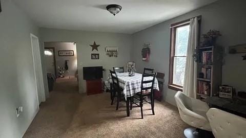 dining space featuring carpet flooring and a wealth of natural light