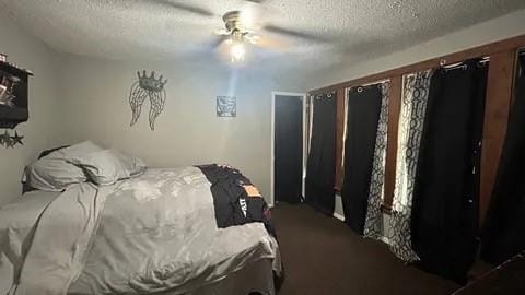 bedroom with a textured ceiling and ceiling fan