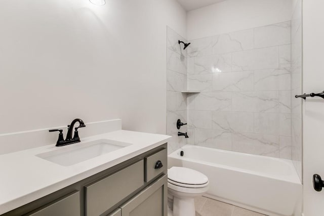 full bathroom featuring tile patterned floors, vanity, toilet, and tiled shower / bath combo