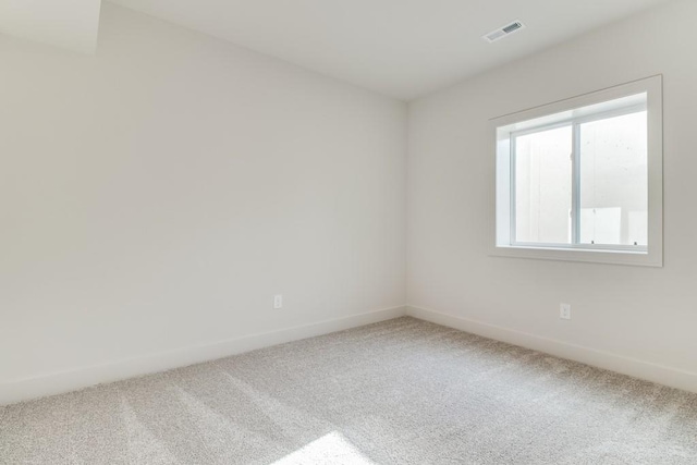 empty room featuring carpet and a wealth of natural light