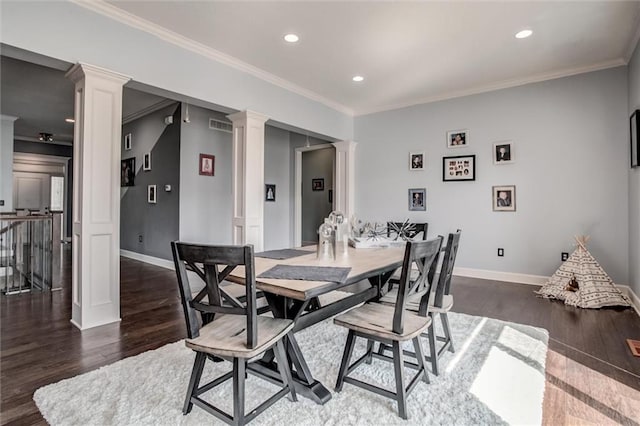 dining room with decorative columns, dark wood-type flooring, and crown molding