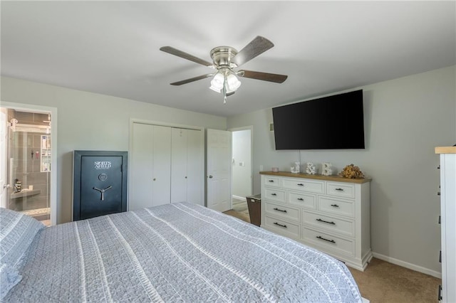 bedroom with a closet, carpet flooring, connected bathroom, and ceiling fan