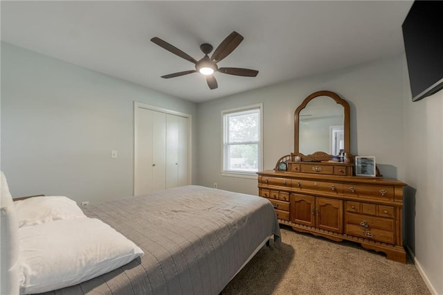 bedroom with a closet, light colored carpet, and ceiling fan