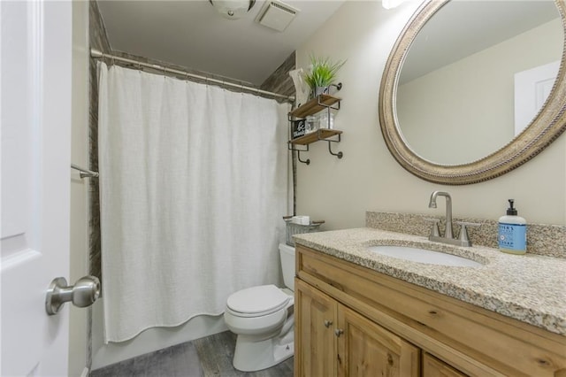 bathroom with wood-type flooring, toilet, and vanity