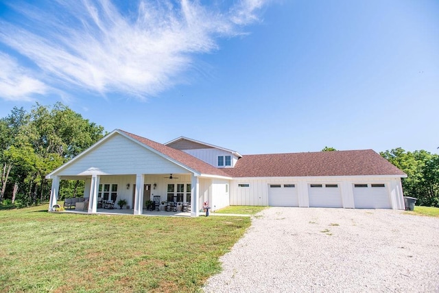 view of front of house with a porch, a garage, and a front yard