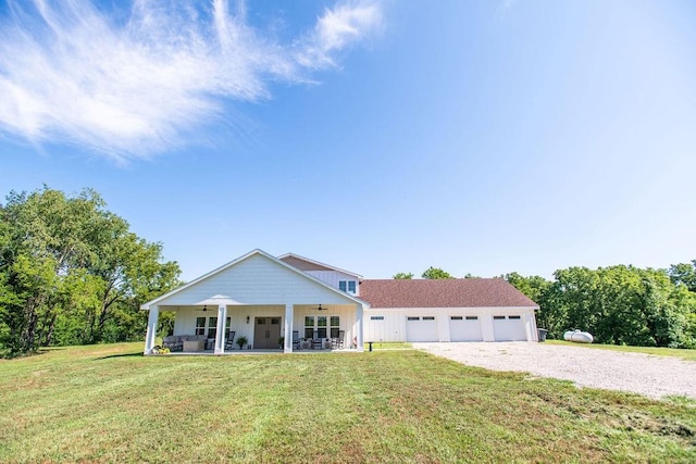 view of front facade featuring a garage, covered porch, and a front lawn