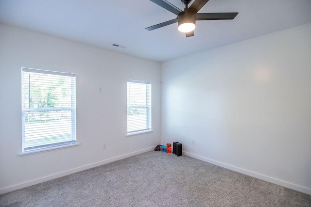 carpeted empty room featuring ceiling fan