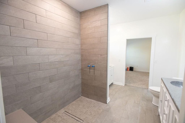 bathroom featuring hardwood / wood-style flooring, toilet, and vanity