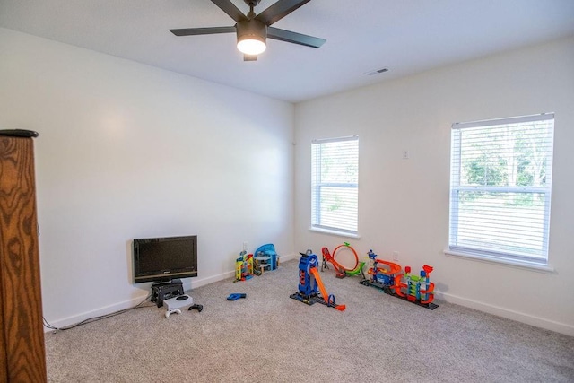 playroom with ceiling fan and carpet flooring