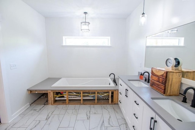 bathroom with a tub, double sink vanity, plenty of natural light, and tile patterned flooring