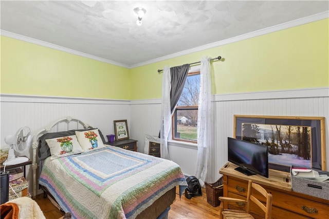 bedroom featuring wood-type flooring and crown molding