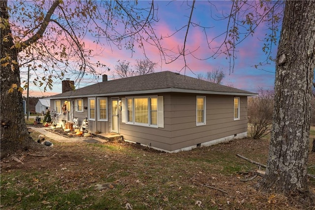 view of back house at dusk