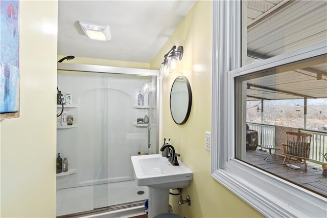 bathroom with an enclosed shower and sink