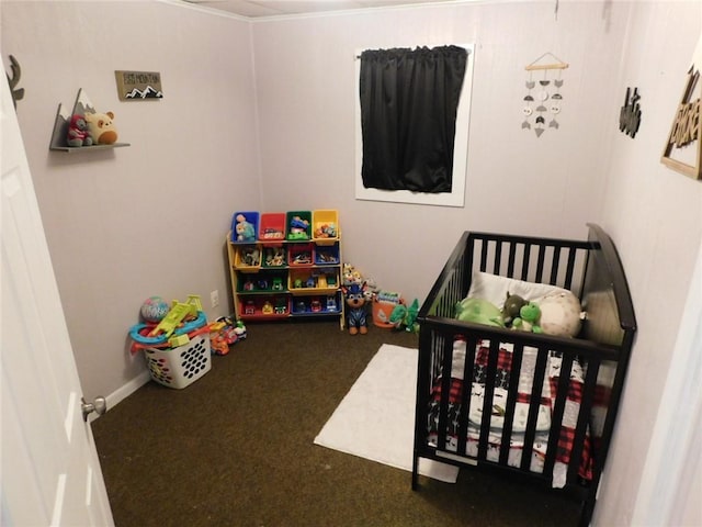 bedroom featuring a crib and dark colored carpet