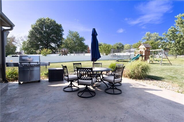 view of patio with a trampoline, a playground, and grilling area