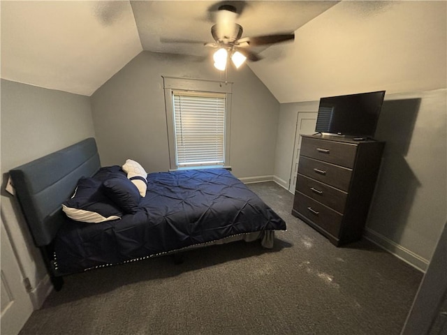 bedroom with dark colored carpet, baseboards, and lofted ceiling