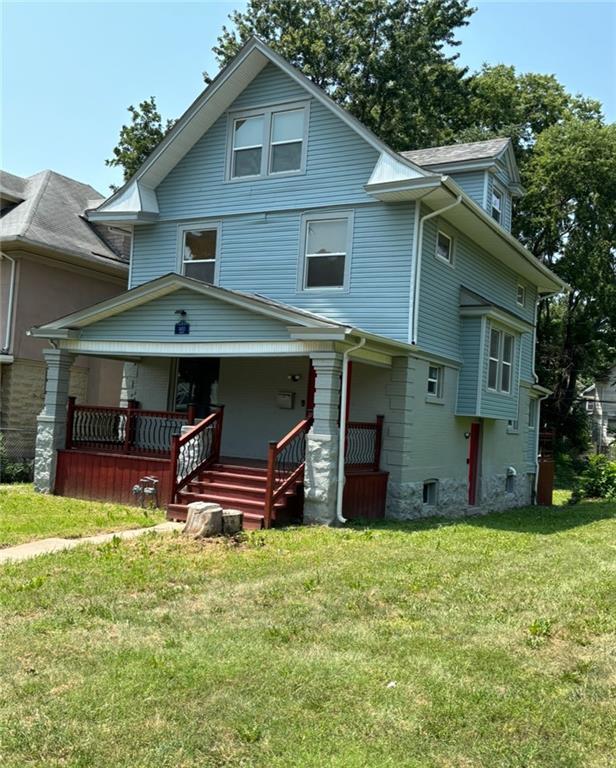 traditional style home with a front lawn and a porch