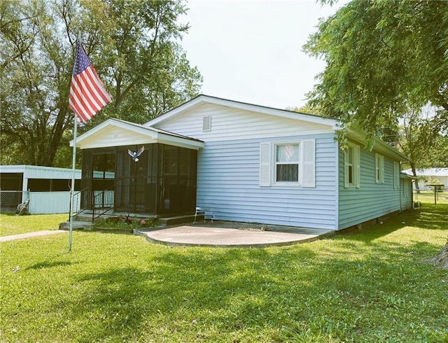 back of house featuring a sunroom and a yard