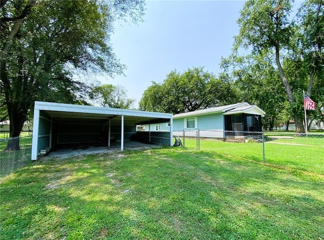 exterior space with a carport, fence, a front lawn, and driveway