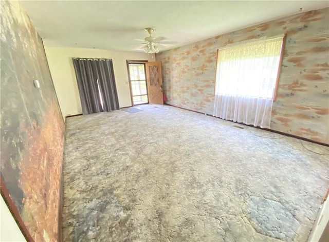 carpeted empty room featuring ceiling fan